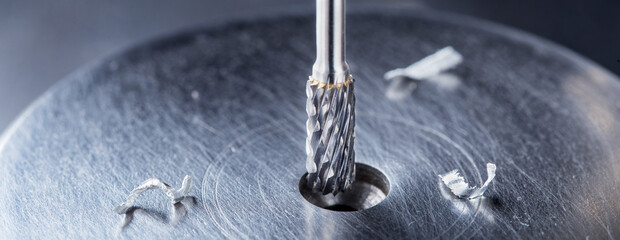 Milling cutter make sink in hole in steel billet. Locksmith work.