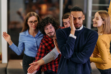 Fototapeta premium A group of young business people have fun playing interesting games while taking a break from work in a modern office. Selective focus 