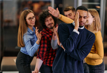 A group of young business people have fun playing interesting games while taking a break from work in a modern office. Selective focus 