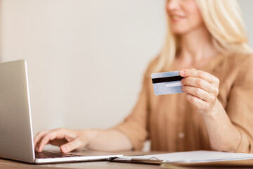 Online Shopping Concept. Woman Using Laptop And Credit Card, Focus On Hand, Empty Space