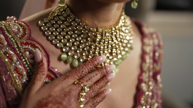 Camera pan over beautiful Gold necklace pakistani bridal getting ready her wedding day, bride wearing