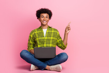 Full size photo of nice young man laptop point finger empty space wear shirt isolated on pink color background