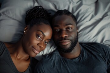 A pair of people resting together on a bed, possibly in a romantic or intimate setting