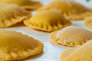 Hand made Ravioli noodles in close up view with soft bokeh background