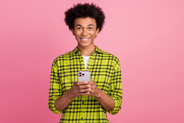 Photo of nice young man use phone chatting wear shirt isolated on pink color background