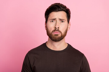 Portrait of sad upset gloomy man with bristle stylish hairdo wear brown shirt looking sadly at you isolated on pink color background