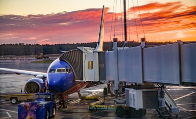 A major airline is loading passengers at sunset at Portland International airport, Oregon