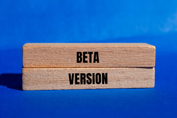 Beta version message written on wooden blocks with blue background. Conceptual beta version symbol. Copy space.