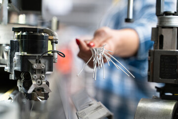 Female industrial worker working with manufacturing equipment in a cable factory