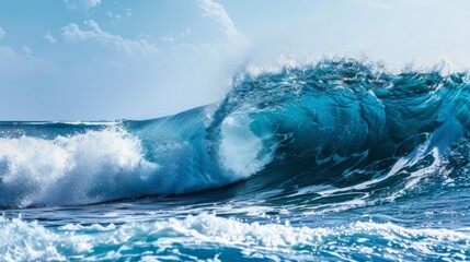 Obraz premium Powerful ocean wave crashing. A large, powerful ocean wave crashing in blue water on a sunny day, perfect for nature and travel themes.