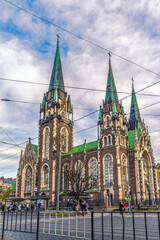 Obraz premium Lviv, Ukraine - November 2,23: Vertical cityscape overlooking a Church of Sts. Olga and Elizabeth against a dramatic sky on an autumn evening in Lviv. Architectural masterpiece in the neo-Gothic style