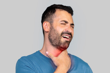 Fototapeta premium Middle aged sick man having sore throat, looking at copy space over grey studio background. Bearded man touching his red neck, suffering from throat disorder, tonsillitis, throat cancer, cold