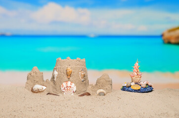 Sand castle and shell ship on sand beach at tropical resort. Family vacation. Relax on the...