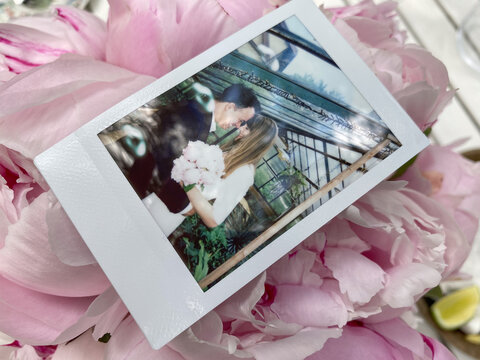 Newlyweds Instant Photo On Pink Flowers Background