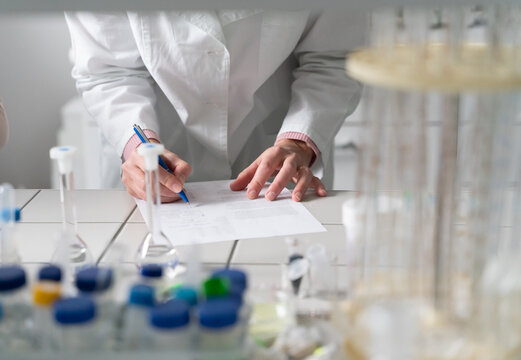 Anonymous Scientist Taking Notes In The Lab