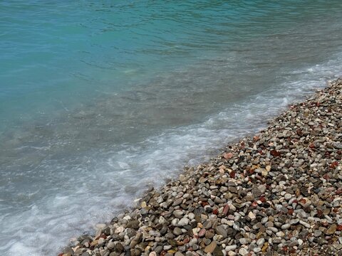  Blue sea waves on the pebble beach