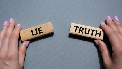 Truth or Lie symbol. Concept word Truth or Lie on wooden blocks. Businessman hand. Beautiful grey...
