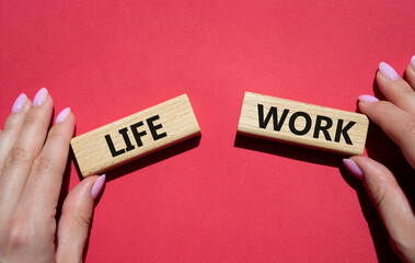 Life or Work symbol. Concept word Life or Work on wooden blocks. Businessman hand. Beautiful red background. Business and Life or Work concept. Copy space