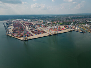 Naklejka premium Panoramic aerial view of Southampton shipping container terminal. Commercial dock in UK. High altitude aerial view of important work place.