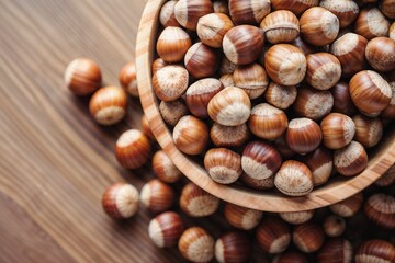 Fototapeta premium Heap of Fresh Hazelnuts in a Wooden Bowl on Rustic Wooden Table