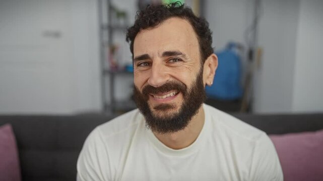 Cheerful middle age man flashing a sexy wink at the camera, wearing a crisp white t-shirt and boasting a happy face expression. welcoming folks from his cozy home