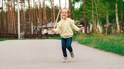 Childhood. Child run on path in spring or summer park. Childhood activity, leisure, lifestyle. Energy, growth, youth concept.
