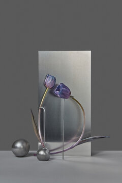 Purple artificial tulips positioned in front of reflective rectangle