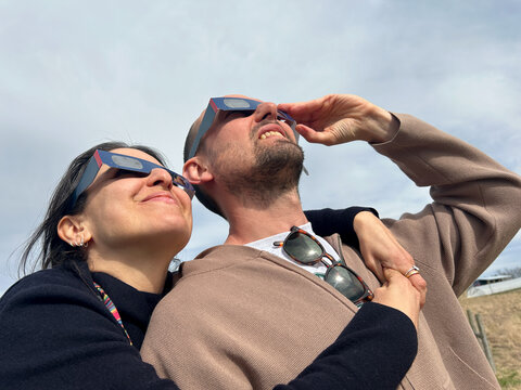 UGC Happy couple hugging during eclipse