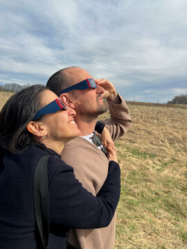 UGC Modern couple hugging during eclipse