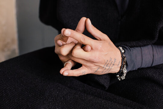 Unrecognizable man making mudra with fingers
