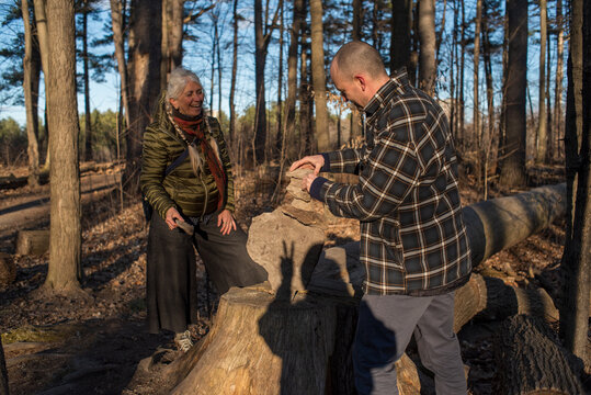Outdoor family moment playing stone balancing