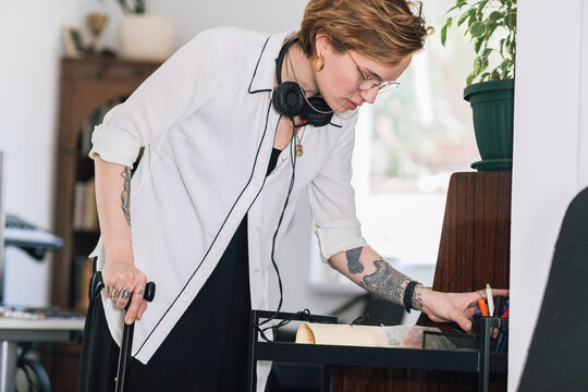 Young Woman Tidying Her Living Room