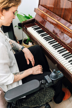 Woman playing piano at home