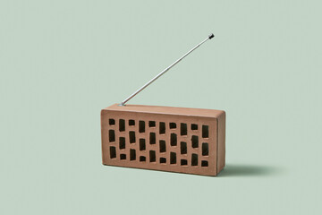 Clinker brick with attached radio antenna isolated in studio