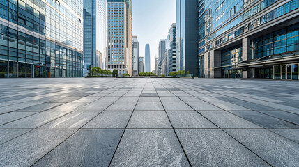 Fototapeta premium A large empty square is in front of modern skyscrapers with gray granite pavers. 