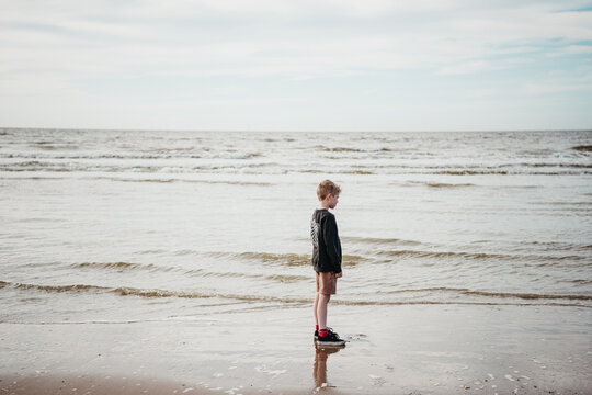 Child looking out at the ocean