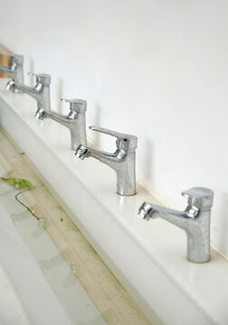 Closeup of a row of rhythmic faucets