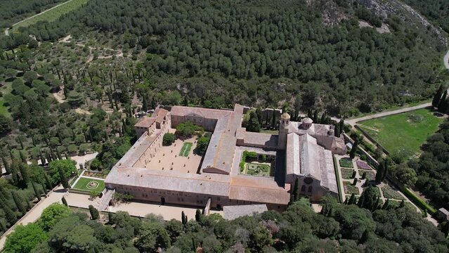 Tilt down aerial shot of Fontfroide Abbey on sunny day. Narbonne, France.