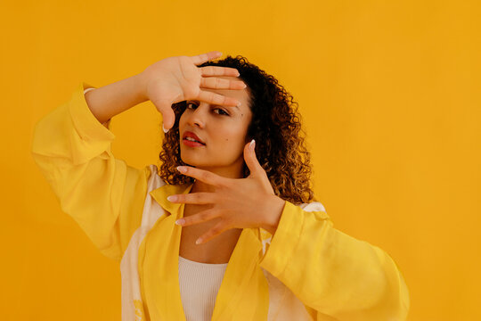 Confident model in stylish outfit dancing in studio