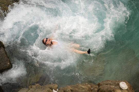 Woman Relaxing in Natural Bubbly Pool Jost Van Dyke BVI Caribbea