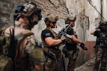 Happy group of airsoft game players at abandoned facility playing game