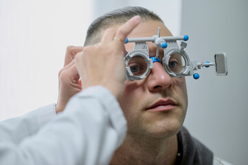 A man doing eye test checking examination with optometrist