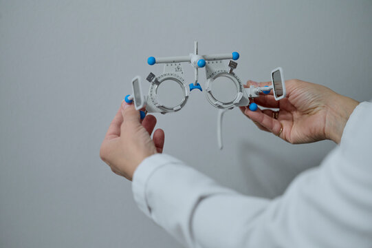 optometrist with an optic instrument