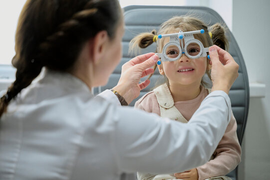 ophthalmologist and smiling kid at ophthalmology center