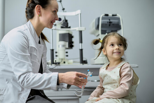 ophthalmologist and smiling kid at ophthalmology center