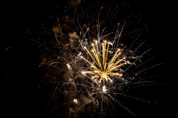 Fototapeta premium Holiday fireworks explode in the night sky. Selective focus. 