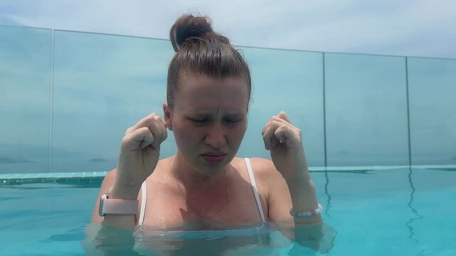 young woman has a problem with her eyes in the pool, chlorine, itchy eyes, summer