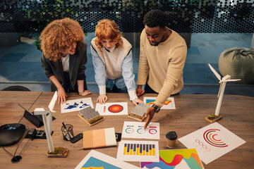 Top view of diverse staff collaborating on renewable energy development