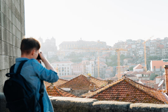 photographer using a dslr camera takes photo of cit