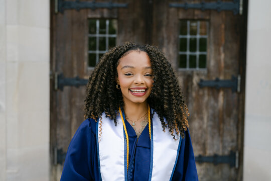 college graduate smiling in her cap and gown 